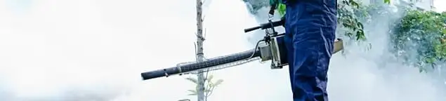 Pest control technician fogging an outdoor area for insect control in Tulsa, OK